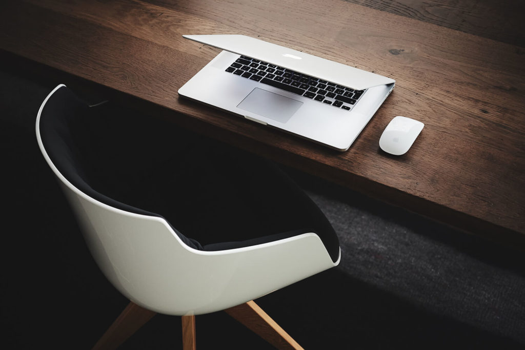 desk and chair with business laptop for a voice over professional